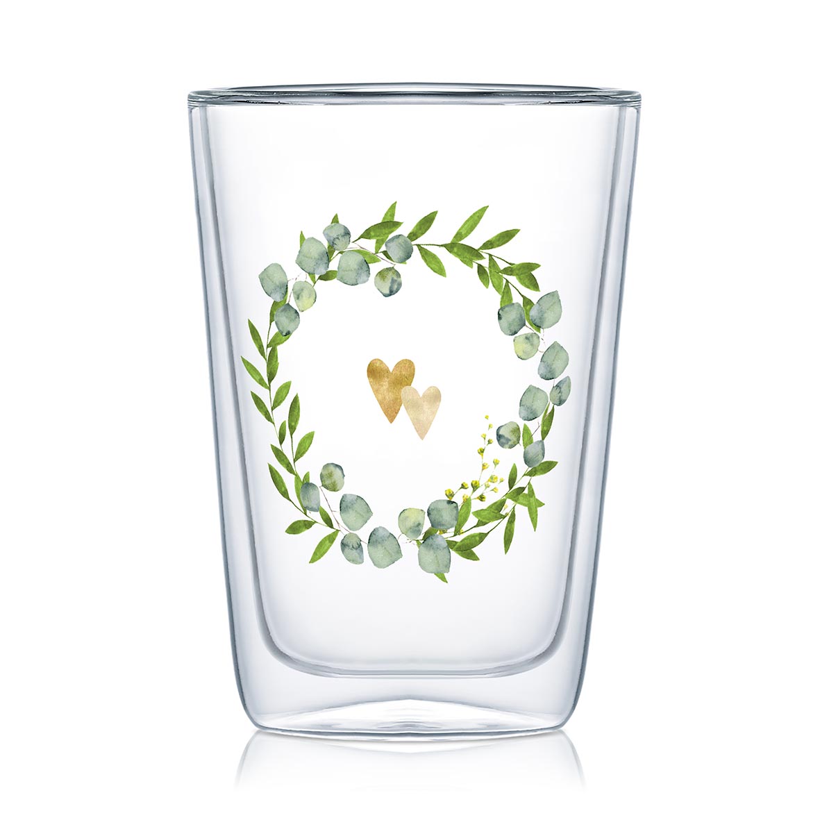 Ein doppelwandiges Glas aus Borosilikatglas mit einem Kranz aus Blättern und zwei goldenen Herzen.