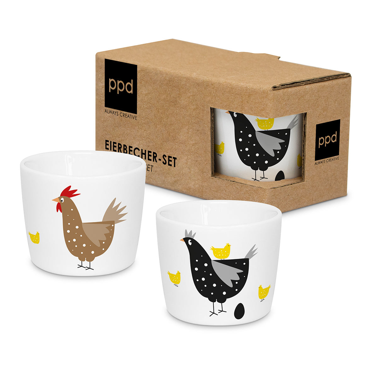 Zwei weiße Eierbecher mit Hühnermotiven in einer braunen Geschenkbox aus Karton.