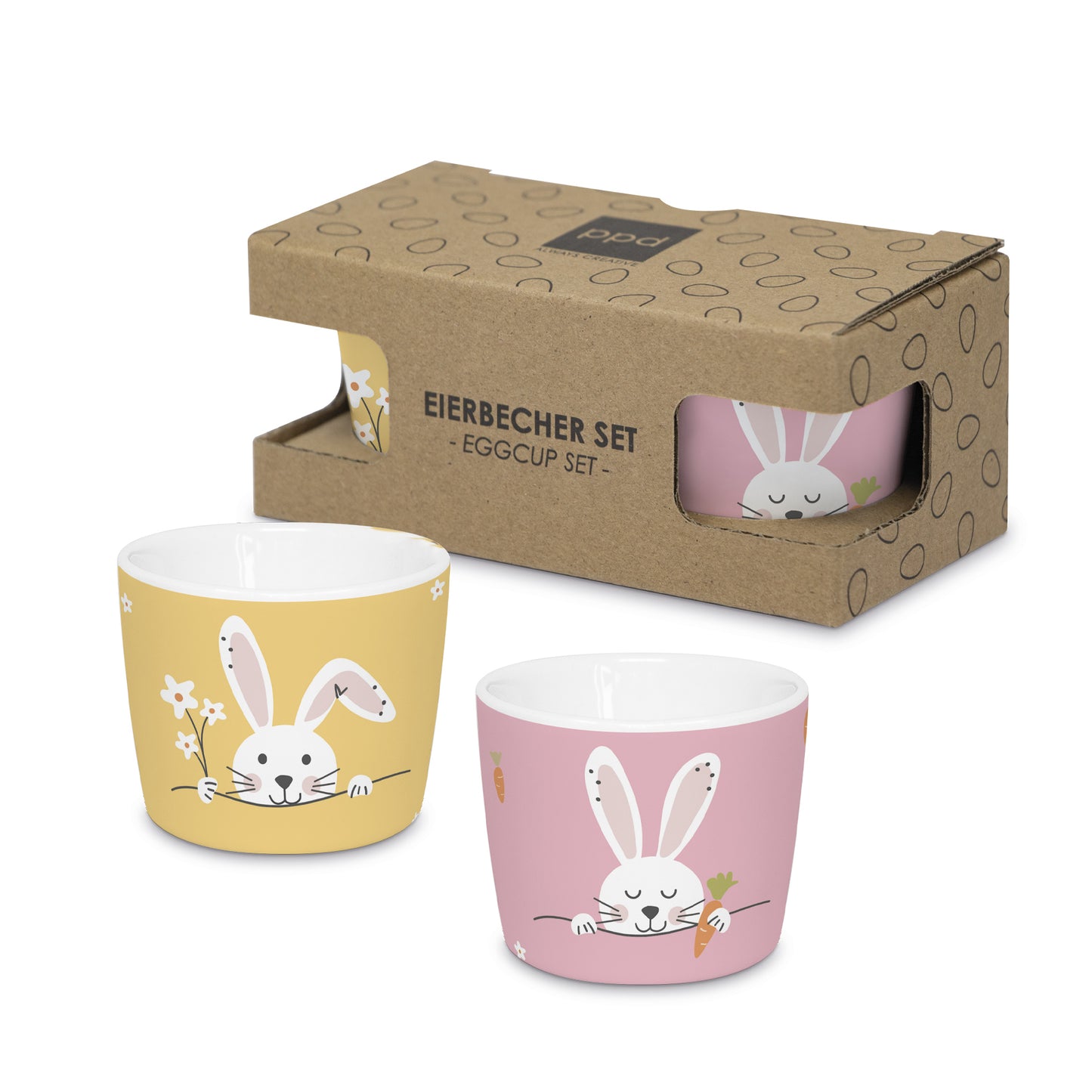 Zwei Eierbecher aus Porzellan mit Hasenmotiven in einer Geschenkbox aus Karton.